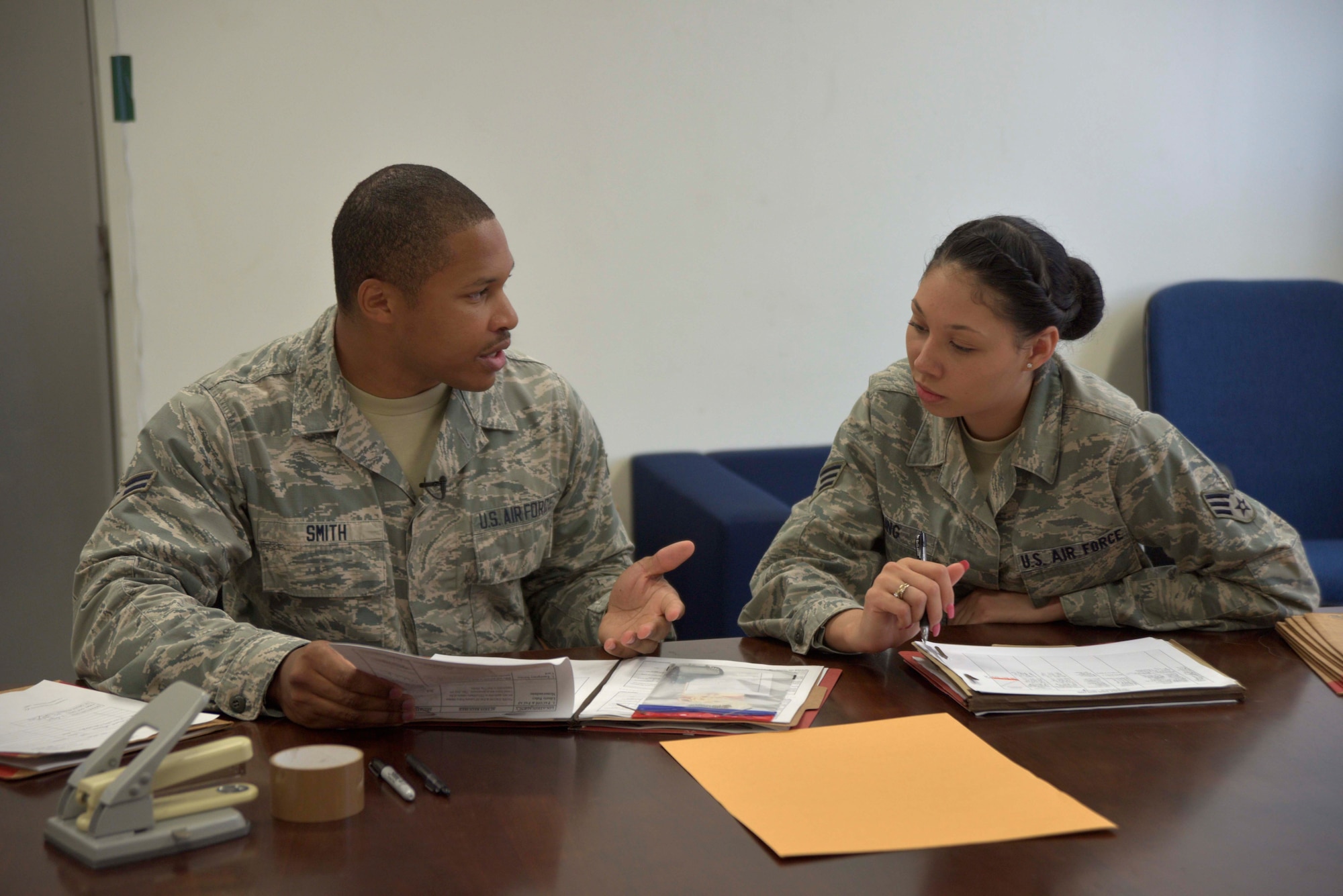 U.S. Air Force Airman 1st Class Spencer Smith, 35th Force Support Squadron installation personnel readiness journeyman, reviews deployment readiness records with Senior Airman Leandra King, 13th Fighter Squadron command support staff and unit deployment manager. Part of Smith’s duties is to work alongside unit deployment managers to ensure accountability of personnel deployed abroad. (U.S. Air Force photo by Senior Airman Jose L. Hernandez-Domitilo)