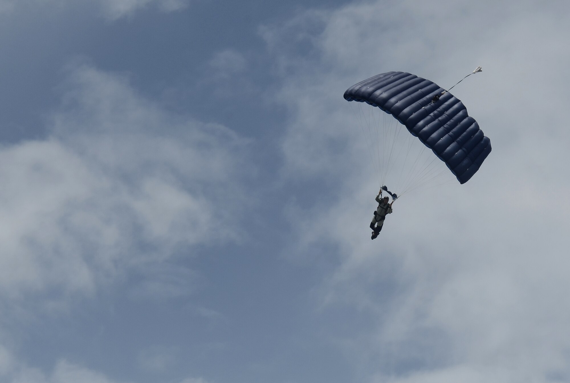 A service member prepares for a parachute landing Aug. 4, 2015 at Andersen Air Force Base, Guam. Airmen, Sailors and Marines assigned to Joint Region Marianas installations took part in regular proficiency training to keep their airborne skills up to date and remain prepared for real-world missions. (U.S. Air Force photo by Airman 1st Class Alexa Ann Henderson/Released)