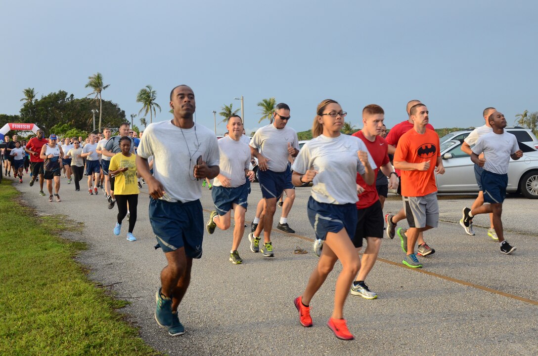 Runners take off during the Superhero Scramble 5K run Aug. 5, 2015, at Andersen Air Force Base, Guam. Some participants donned their superhero outfits while others wore their favorite superhero T-shirt. (U.S. Air Force photo by Airman 1st Class Alexa Ann Henderson/Released)