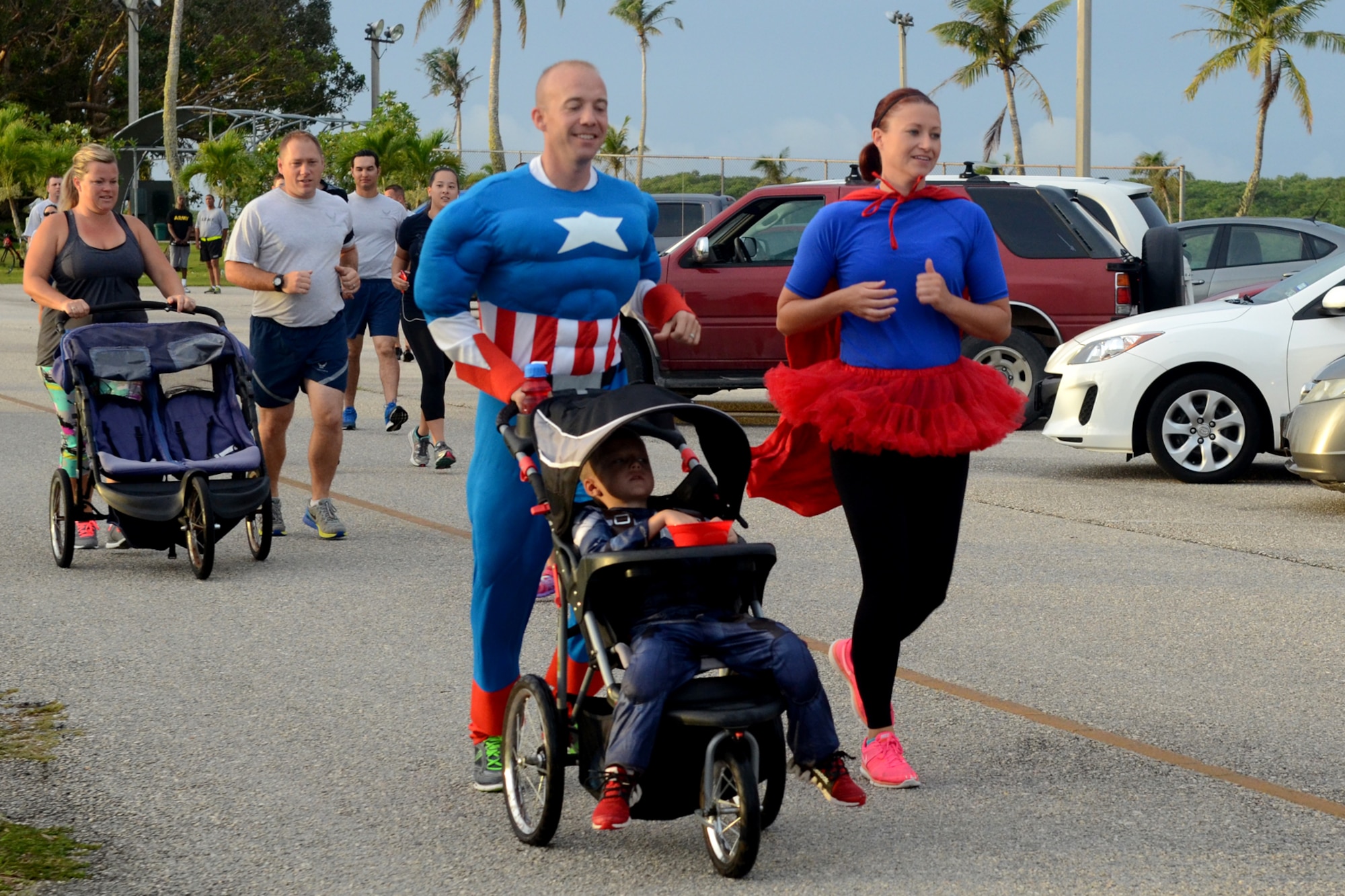 Airmen and family members participate in a Superhero Scramble 5K run Aug. 5, 2015, at Andersen Air Force Base, Guam. Some participants donned their superhero outfits while others wore their favorite superhero T-shirt. (U.S. Air Force photo by Airman 1st Class Alexa Ann Henderson/Released)