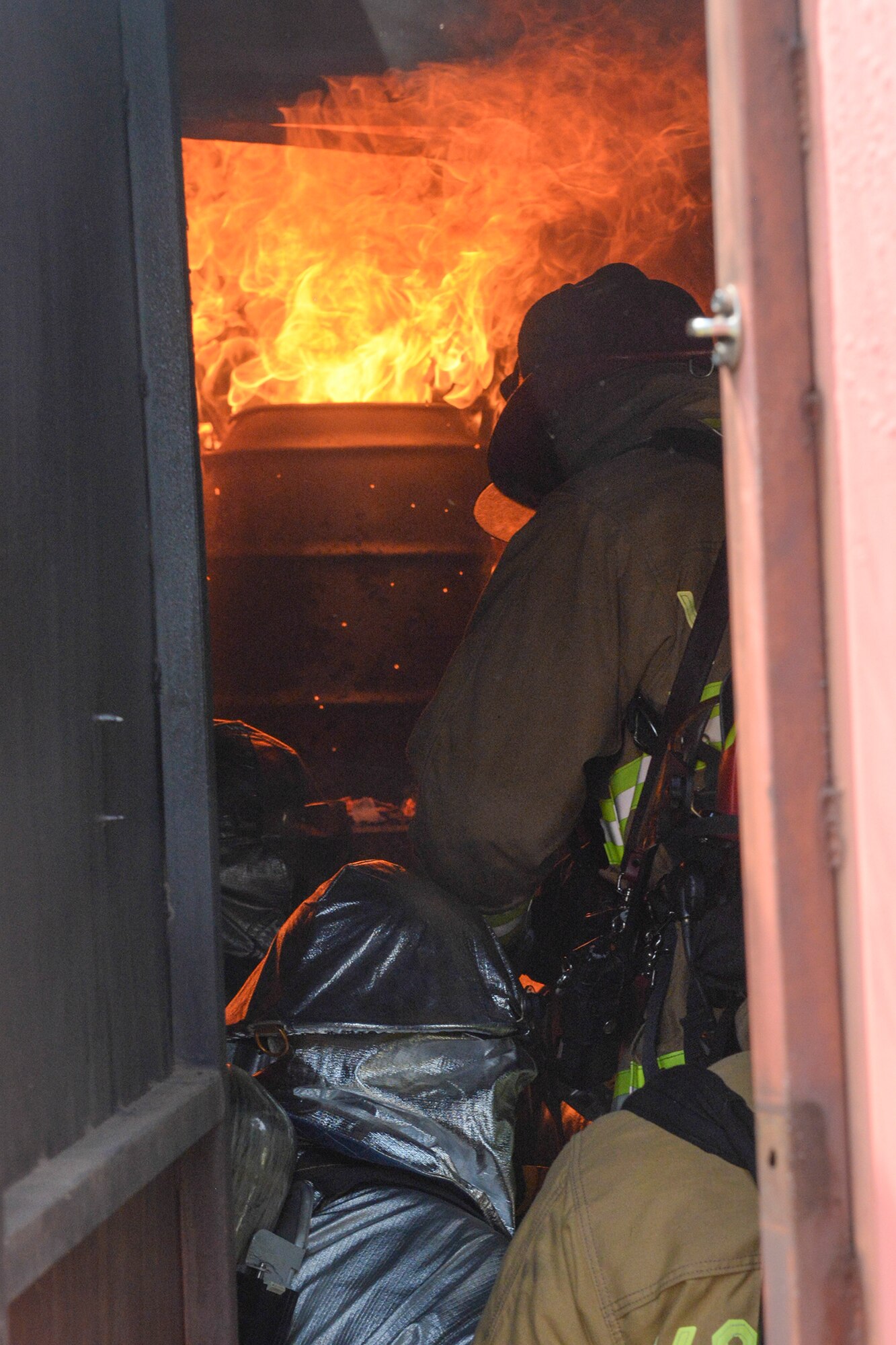 Marine Corps Air Station Iwakuni firefighters and 374th Civil Engineer Squadron firefighters team up to combat a controlled blaze at Yokota Air Base, Japan, Aug. 4, 2015. Airmen and Marine firefighters came together for a day of training, utilizing Yokota’s unique training capabilities to enhance emergency readiness. (U.S. Air Force photo by Airman 1st Class Elizabeth Baker/ Released)