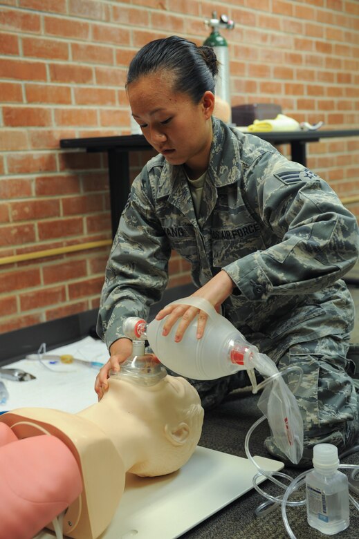 U.S. Air Force Senior Airman Mia Yang, 99th Reconnaissance Squadron Beale Air Force Base Calif., medical technician, uses a bag valve mask on a practice manikin at the Pima Community College Public Safety Emergency and Services Institute, Tucson, Ariz., July 29, 2015. Yang was a student paramedic going through a paramedic training course offered strictly to Airmen at PSESI. (U.S. Air Force photo by Airmen 1st class Cheyenne Morigeau/Released)