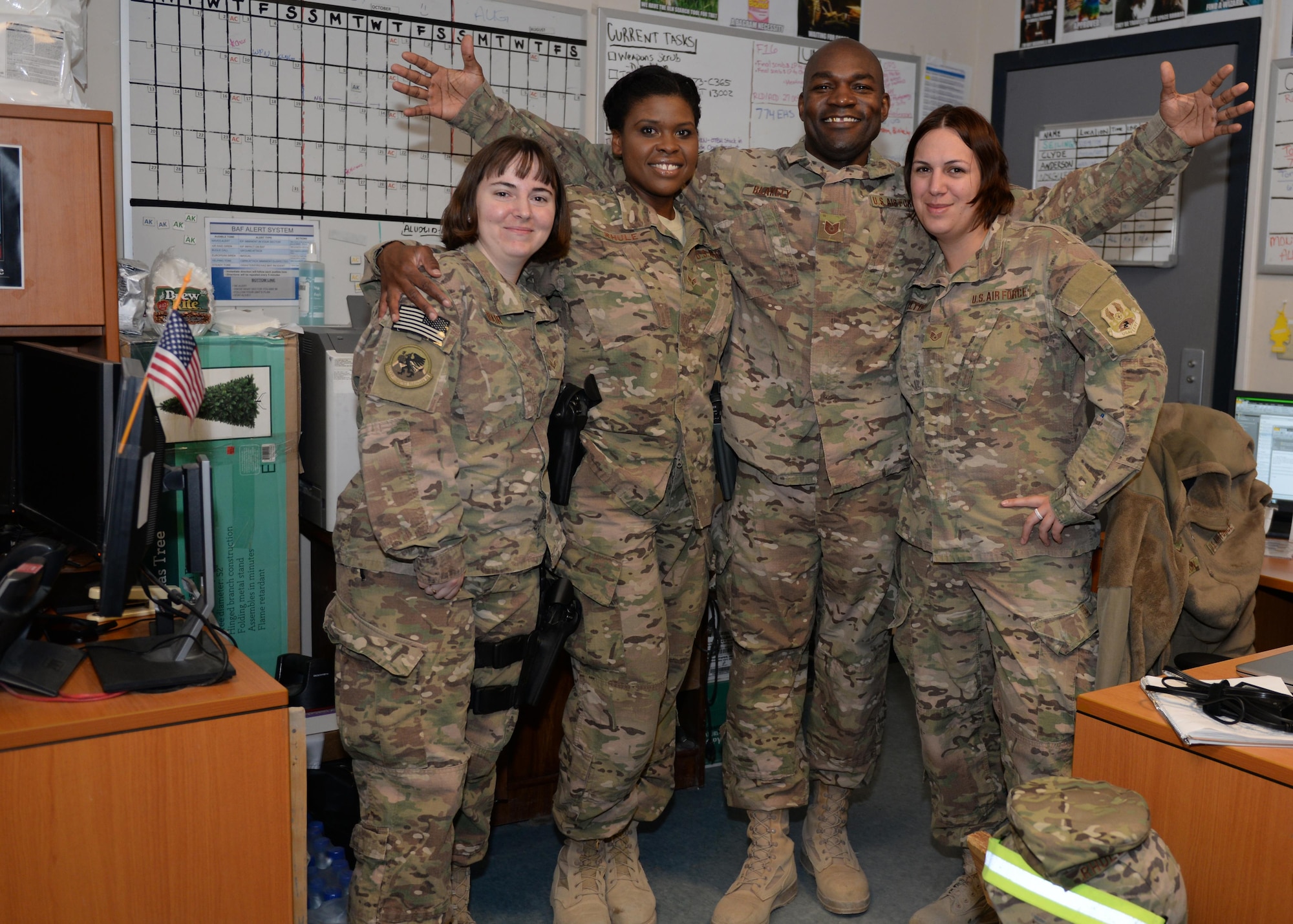 U.S. Airmen assigned to the 455th Expeditionary Logistics Readiness Squadron passenger terminal pose for a photo Aug. 4, 2015, at Bagram Airfield, Afghanistan. The PAX terminal team is responsible for ensuring all Bagram Airmen redeploy back to home station when they reach the end of their deployment here. (U.S. Air Force photo by Senior Airman Cierra Presentado/Released)