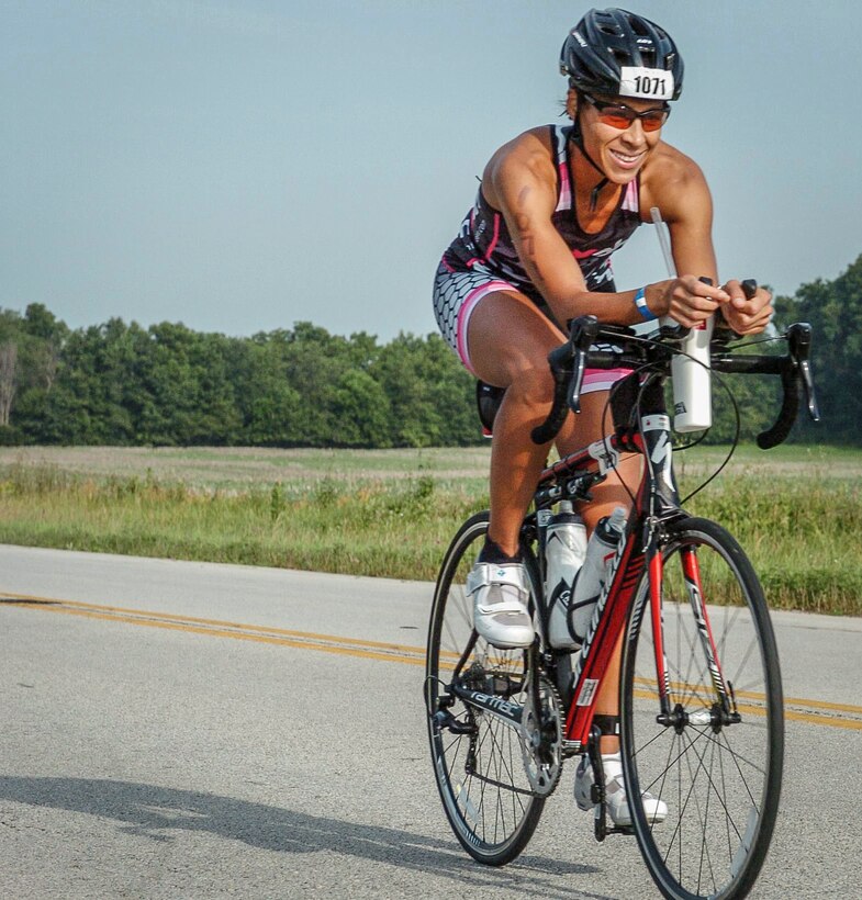 Maj. Christina Hopper bikes during the Ironman 70.3 Muncie at Muncie, Indiana, July 11. Hopper completed her 56-mile bike ride in 2:44:29. (Courtesy photo by finisherpix)