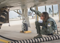 Maj. Christina Hopper conducts a comprehensive check of her T-38 Talon on the flightline at Vance Air Force Base, Oklahoma, July 20. (U.S. Air Force photo by David Poe)