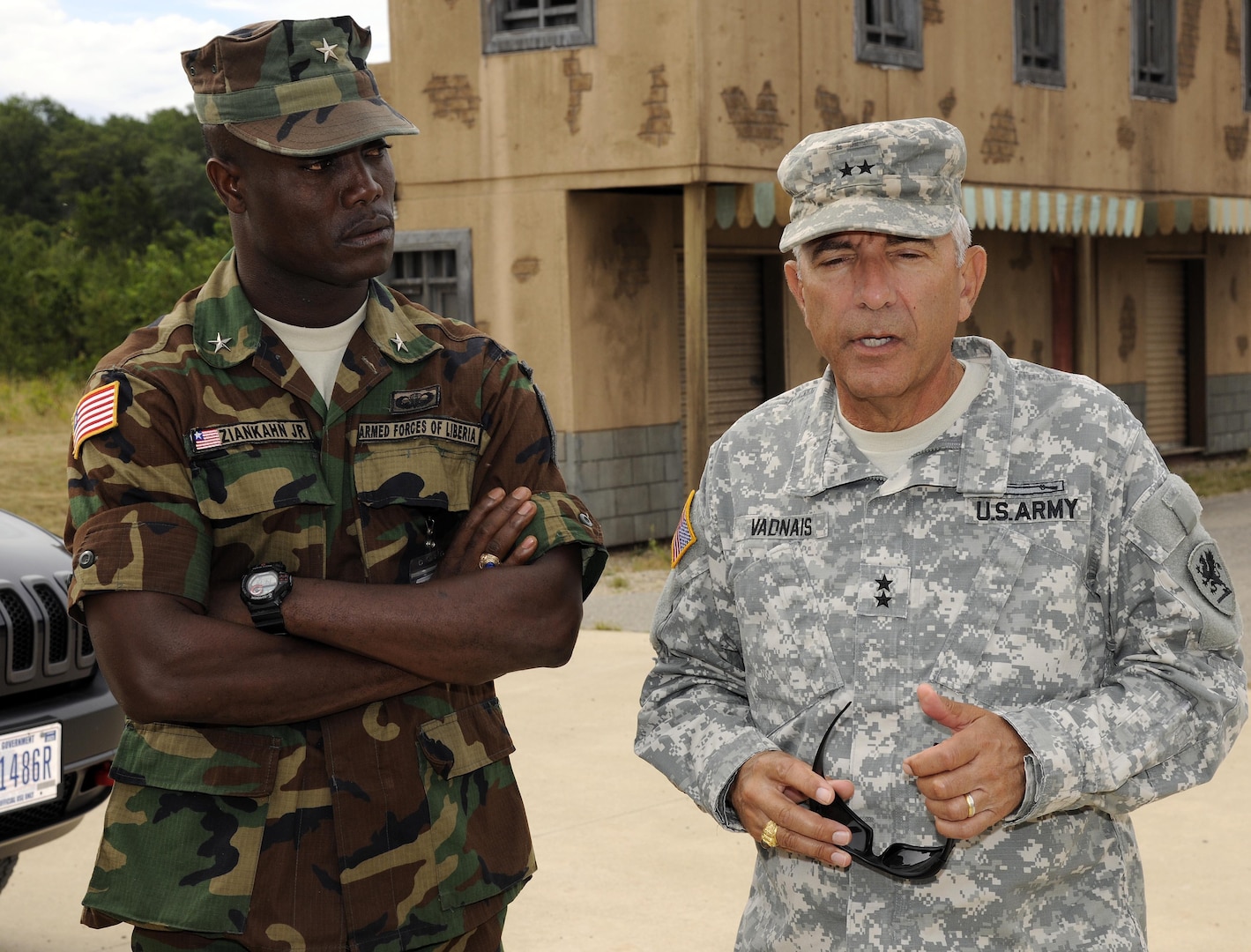 Michigan National Guard Adjutant General Maj. Gen. Gregory J. Vadnais, the adjutant general of Michigan, speaks with Brig. Gen. Daniel D. Ziankahn Jr., chief of staff of the Armed Forces of Liberia, at the counter-improvised explosive device range at the Camp Grayling Joint Maneuver Training Center in Grayling, Michigan, Aug. 2, 2015. Michigan and Liberia have been partners under the U.S. National Guard’s State Partnership Program since 2009. 