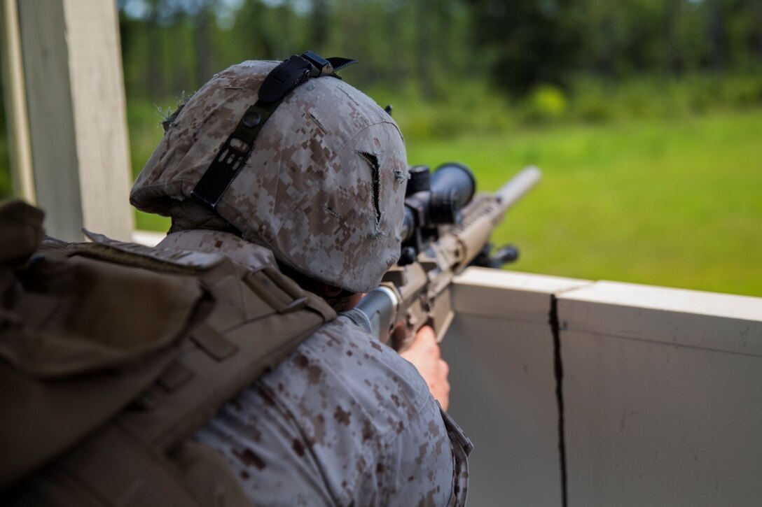 Lance Cpl. Hunter Ladrum, a designated marksman with Bravo Company, 2nd Law Enforcement Battalion, II Marine Expeditionary Force Headquarters Group, sights in on possible threats during a week-long exercise at GSRA FOB aboard Camp Lejeune, North Carolina, August 5, 2015. The company conducted the training from August 4-7, in which they simulated the protection of a submarine during fueling operations.