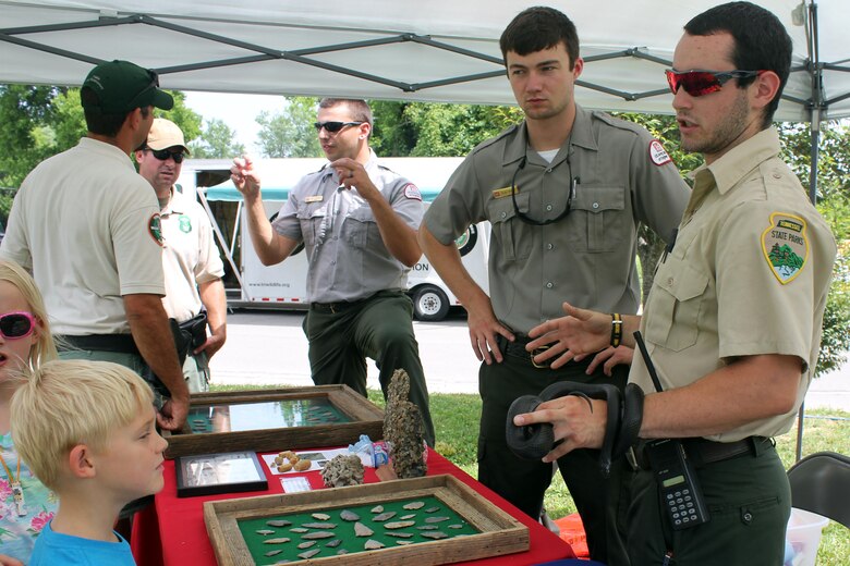Summer Ranger Dylan Hamlet (left) and a Tennessee State Park summer ranger discuss some of the native snake species found around Center Hill Lake at the DeKalb County Get Outdoors Day June 13, 2015. 