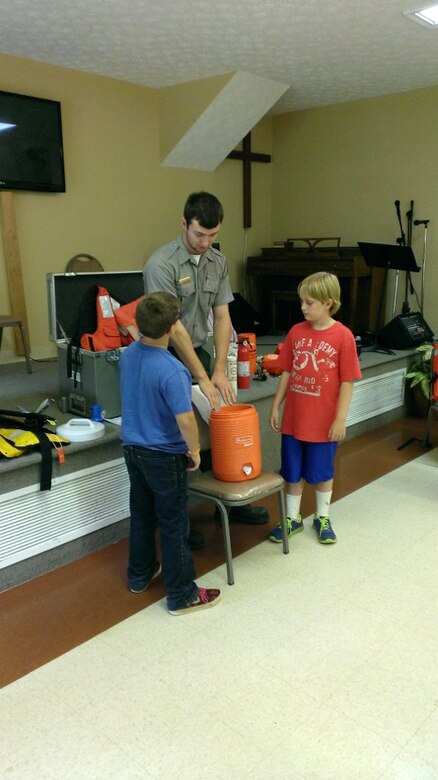 Summer Ranger Dylan Hamlet recruits volunteers to demonstrate the dangers of hypothermia during a water safety program July 7, 2015 at Lighthouse Christian Camp in Smithville, Tenn.