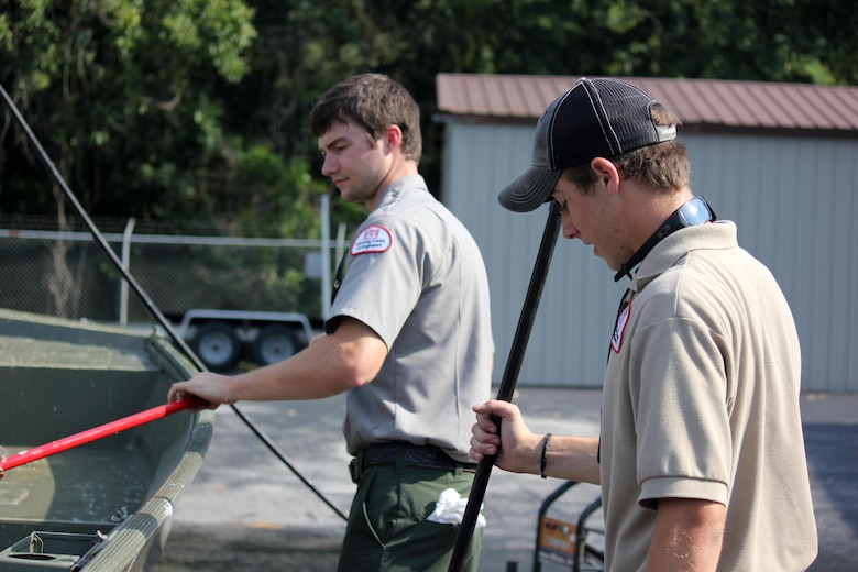 Summer Ranger Dylan Hamlet works with a volunteer to clean out a Corps vessel at Center Hill Lake’s maintenance facility Aug. 4, 2015. 