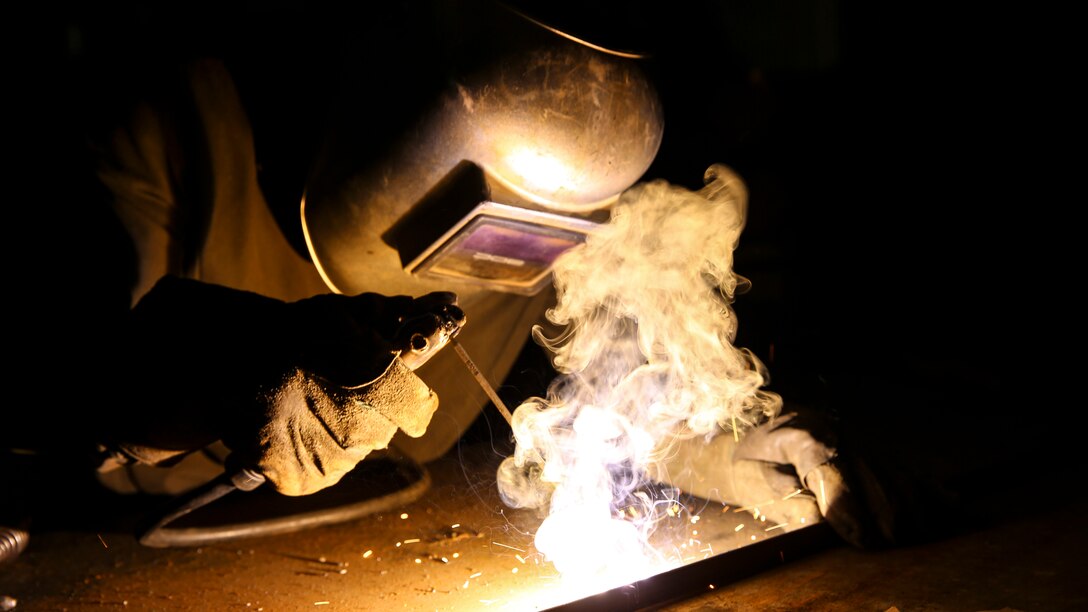 U.S. Marine Sgt. Arnet Moore, a welder with the Logistics Combat Element, Special Purpose Air-Ground Task Force-Crisis Response-Central Command, welds a piece of metal for a project in Southwest Asia, July 19, 2015.