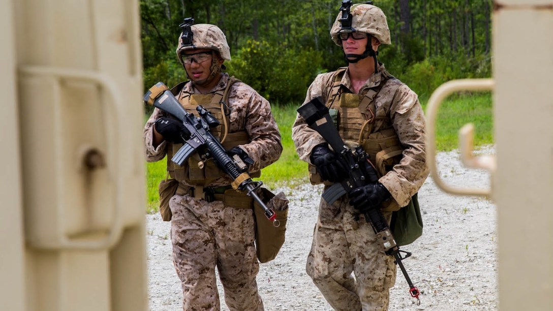 Corporal Eduardo Tovar (left) and Lance Cpl. Tim Kerschner (right), military policemen with Bravo Company, 2nd Law Enforcement Battalion, II Marine Expeditionary Force Headquarters Group, patrol around GSRA FOB, looking for possible intruders aboard Camp Lejeune, North Carolina, August 5, 2015. The company conducted a week long exercise, from August 4-7, in preparation for an upcoming deployment, where they will have to take on the roles of security forces and protect valuable assets.