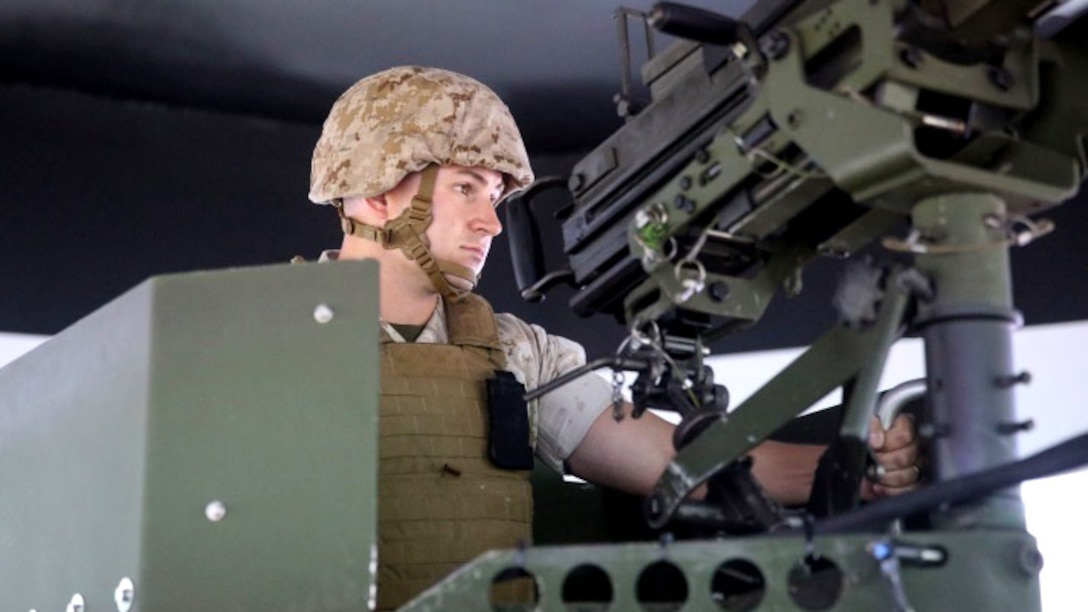 Sergeant Kyle Owens, a Motor Transport mechanic with Headquarters Platoon, 2nd Naval Air Gunfire Liaison Company, II Marine Expeditionary Force Headquarters Group, mans the turret while conducting convoy simulations training at Marine Corps Base Camp Lejeune, North Carolina, August 4, 2015. The combat convoy simulators provide an immersive environment for convoy operations training for command and control procedures in tactical scenarios related to combat operations.