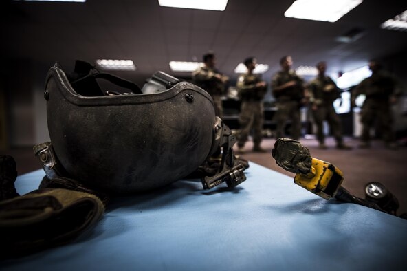 Airmen with the 1st Special Operations Security Forces Squadron deployed aircraft ground response element team members, prepare their gear before a task force exercise on Hurlburt Field, Fla., July 28, 2015. Exercise scenarios included downed aircraft site security and armed escort. Through the scenarios, DAGRE was able to accomplish multiple training objectives including close quarters combat, small unit tactics, flight deck denial, fly away security, close air support, casualty evacuation and more. (U.S. Air Force photo by Senior Airman Christopher Callaway)