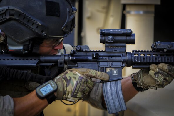 Senior Airman Daniel Santana, 1st Special Operations Security Forces Squadron deployed aircraft ground response element team member, provides cover fire during a task force exercise on Eglin Range Complex, Fla., July 27, 2015. Exercise scenarios included downed aircraft site security and armed escort. Through the scenarios, DAGRE was able to accomplish multiple training objectives including close quarters combat, small unit tactics, flight deck denial, fly away security, close air support, casualty evacuation and more. (U.S. Air Force photo by Senior Airman Christopher Callaway)