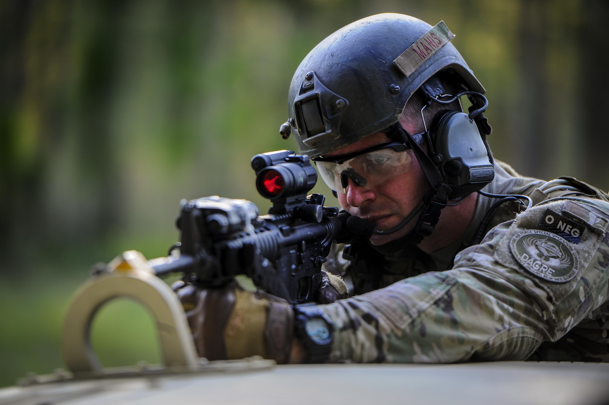 Senior Airman William Manis, 1st Special Operations Security Forces Squadron deployed aircraft ground response element team member, provides cover fire during a task force exercise on Eglin Range Complex, Fla., July 27, 2015. Exercise scenarios included downed aircraft site security and armed escort. Through the scenarios, DAGRE was able to accomplish multiple training objectives including close quarters combat, small unit tactics, flight deck denial, fly away security, close air support, casual evacuation and more. (U.S. Air Force photo by Senior Airman Christopher Callaway)