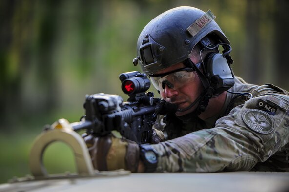 Senior Airman William Manis, 1st Special Operations Security Forces Squadron deployed aircraft ground response element team member, provides cover fire during a task force exercise on Eglin Range Complex, Fla., July 27, 2015. Exercise scenarios included downed aircraft site security and armed escort. Through the scenarios, DAGRE was able to accomplish multiple training objectives including close quarters combat, small unit tactics, flight deck denial, fly away security, close air support, casualty evacuation and more. (U.S. Air Force photo by Senior Airman Christopher Callaway)