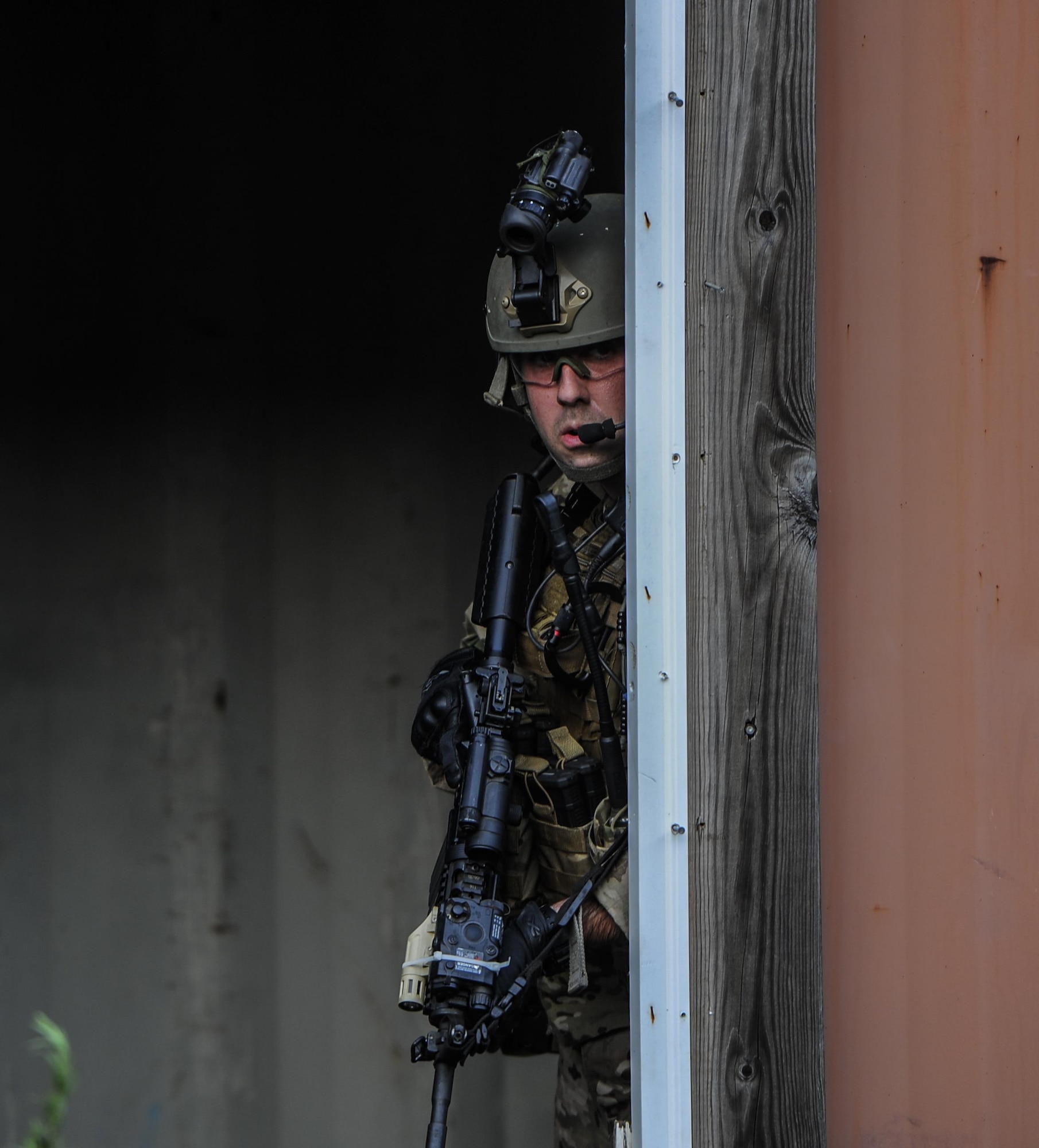 Senior Airman Daniel Willens, 1st Special Operations Security Forces Squadron deployed aircraft ground response element team member, provides cover during a task force exercise on Eglin Range Complex, Fla., July 27, 2015. Exercise scenarios included downed aircraft site security and armed escort. Through the scenarios, DAGRE was able to accomplish multiple training objectives including close quarters combat, small unit tactics, flight deck denial, fly away security, close air support, casual evacuation and more. (U.S. Air Force photo by Senior Airman Christopher Callaway)