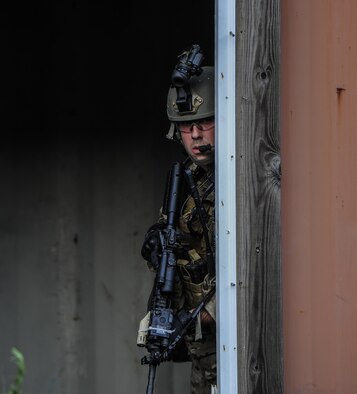 Senior Airman Daniel Willens, 1st Special Operations Security Forces Squadron deployed aircraft ground response element team member, provides cover during a task force exercise on Eglin Range Complex, Fla., July 27, 2015. Exercise scenarios included downed aircraft site security and armed escort. Through the scenarios, DAGRE was able to accomplish multiple training objectives including close quarters combat, small unit tactics, flight deck denial, fly away security, close air support, casualty evacuation and more. (U.S. Air Force photo by Senior Airman Christopher Callaway)