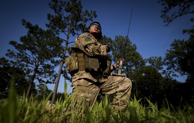 Airman 1st Class Ricardo Maggin, 1st Special Operations Security Forces Squadron deployed aircraft ground response element team member, checks for a radio connection between ground and air forces during a task force exercise on Eglin Range Complex, Fla., July 27, 2015. Exercise scenarios included downed aircraft site security and armed escort. Through the scenarios, DAGRE was able to accomplish multiple training objectives including close quarters combat, small unit tactics, flight deck denial, fly away security, close air support, casualty evacuation and more. (U.S. Air Force photo by Senior Airman Christopher Callaway)