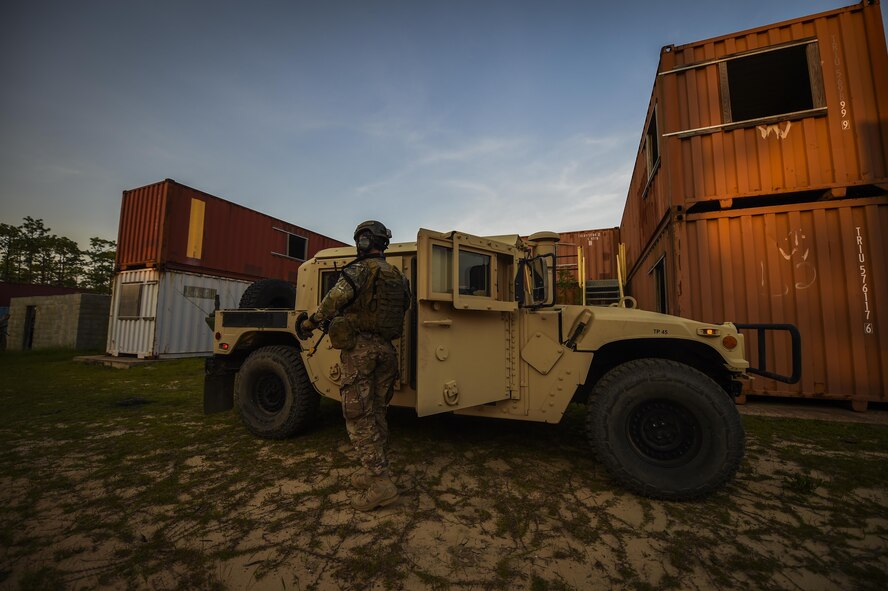 Senior Airman William Manis, 1st Special Operations Security Forces Squadron deployed aircraft ground response element team member, prepares to scan the terrain for hostile forces during a task force exercise on Eglin Range Complex, Fla., July 28, 2015. Exercise scenarios included downed aircraft site security and armed escort. Through the scenarios, DAGRE was able to accomplish multiple training objectives including close quarters combat, small unit tactics, flight deck denial, fly away security, close air support, casual evacuation and more. (U.S. Air Force photo by Senior Airman Christopher Callaway)