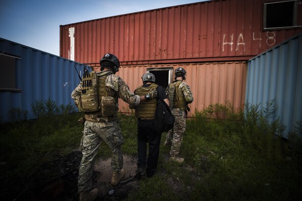 Team members with the 1st Special Operations Security Forces Squadron deployed aircraft ground response element provide an armed escort for a simulated high-ranking government official during a task force exercise on Eglin Range Complex, Fla., July 28, 2015. Exercise scenarios included downed aircraft site security and armed escort. Through the scenarios, DAGRE was able to accomplish multiple training objectives including close quarters combat, small unit tactics, flight deck denial, fly away security, close air support, casualty evacuation and more. (U.S. Air Force photo by Senior Airman Christopher Callaway)
