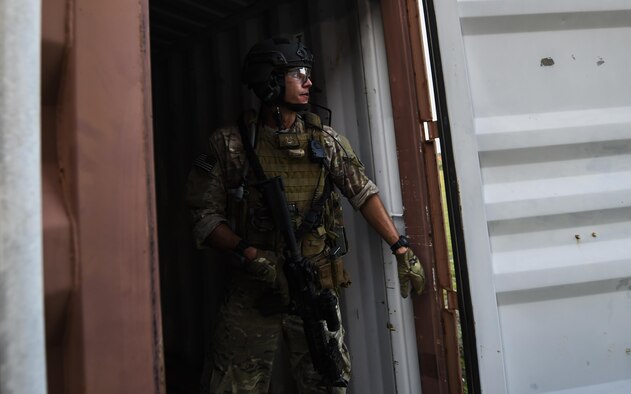 Senior Airman Daniel Santana, 1st Special Operations Security Forces Squadron deployed aircraft ground response element team member, provides cover during a task force exercise on Eglin Range Complex, Fla., July 28, 2015. Exercise scenarios included downed aircraft site security and armed escort. Through the scenarios, DAGRE was able to accomplish multiple training objectives including close quarters combat, small unit tactics, flight deck denial, fly away security, close air support, casualty evacuation and more. (U.S. Air Force photo by Senior Airman Christopher Callaway)