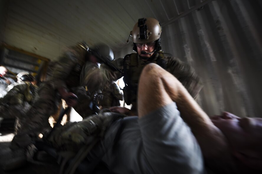 Senior Airman Jason Fernandez, 1st Special Operations Security Forces Squadron deployed aircraft ground response element team member, provides medical support to an injured victim during a task force exercise on Eglin Range Complex, Fla., July 28, 2015. Exercise scenarios included downed aircraft site security and armed escort. Through the scenarios, DAGRE was able to accomplish multiple training objectives including close quarters combat, small unit tactics, flight deck denial, fly away security, close air support, casualty evacuation and more. (U.S. Air Force photo by Senior Airman Christopher Callaway)
