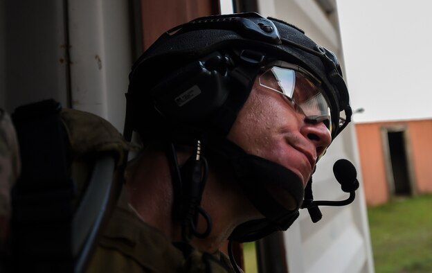 Senior Airman Daniel Santana, 1st Special Operations Security Forces Squadron deployed aircraft ground response element team member, scans his area of responsibility for simulated hostile forces during a task force exercise on Eglin Range Complex, Fla., July 28, 2015. Exercise scenarios included downed aircraft site security and armed escort. Through the scenarios, DAGRE was able to accomplish multiple training objectives including close quarters combat, small unit tactics, flight deck denial, fly away security, close air support, casualty evacuation and more. (U.S. Air Force photo by Senior Christopher Callaway)