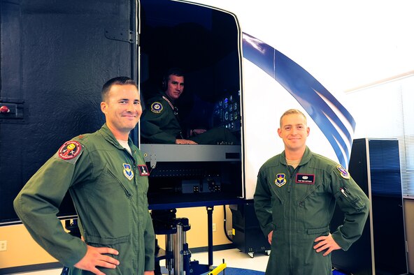 Col. James Fisher, 14th Flying Training Wing Vice Commander, pauses in the cockpit of the new Spatial Disorientation simulator with Maj. Michael Fleming, 14th Medical Group Aerospace and Operational Physiology Flight Commander, and Tech. Sgt. Benjamin Hoffman, AOP Flight Chief, in the AOP simulator training room Aug. 5 on Columbus Air Force Base, Mississippi. Fisher visited AOP to experience first-hand the new Spatial Disorientation trainer in action. (U.S. Air Force photo by Airman 1st Class John Day)