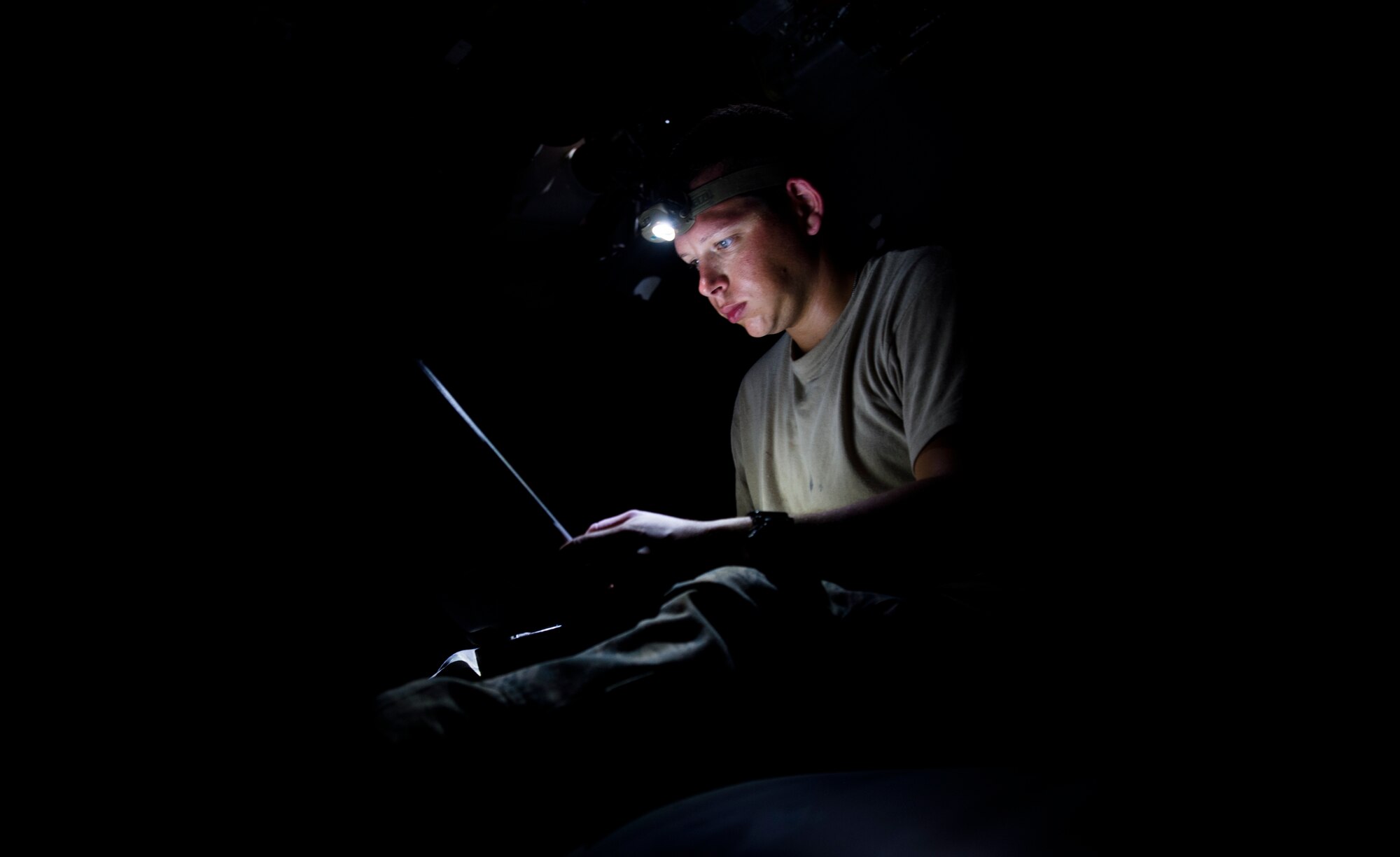 Staff Sgt. Sam Johnston, 801st Special Operations Aircraft Maintenance Squadron crew chief, reviews the technical orders of a CV-22B Osprey during maintenance on Eglin Range Complex, Fla., July 29, 2015. Johnston and two other maintainers were flown out to the range to perform routine repairs on a CV-22B Osprey that was used during a recent six-day task force exercise at Hurlburt Field, Fla. (U.S. Air Force photo/Senior Airman Christopher Callaway)