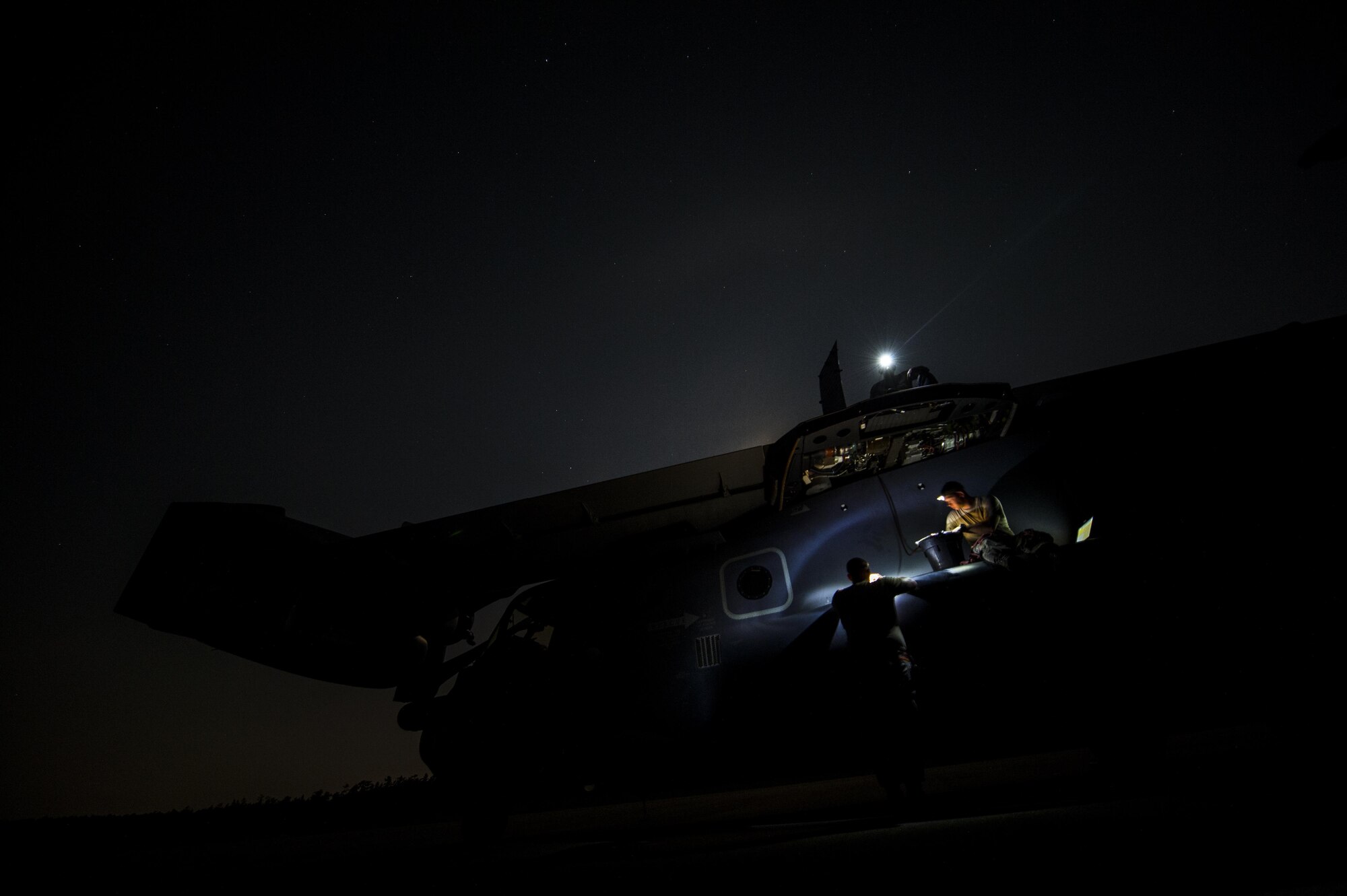 Maintainers with the 801st Special Operations Aircraft Maintenance Squadron flush a CV-22B Osprey fuel line during routine repairs on the Eglin Range Complex, Fla., July 29, 2015. The Osprey played an integral role during a recent task force exercise at Hurlburt Field, Fla. (U.S. Air Force photo/Senior Airman Christopher Callaway)