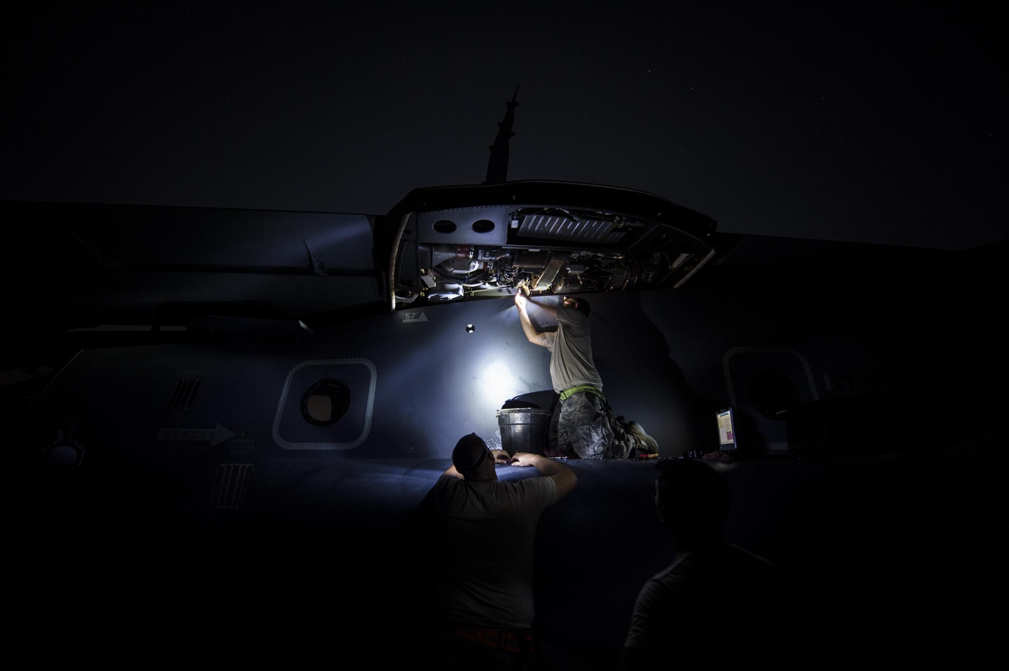 Staff Sgt. Sam Johnston, 801st Special Operations Aircraft Maintenance Squadron crew chief, and two other maintainers with the 801st SOAMXS, perform routine CV-22B Osprey repairs on Eglin Range Complex, Fla., July 29, 2015. The Osprey played an integral role for casualty evacuation training during the recent six-day task force exercise at Hurlburt Field, Fla. (U.S. Air Force photo/Senior Airman Christopher Callaway)