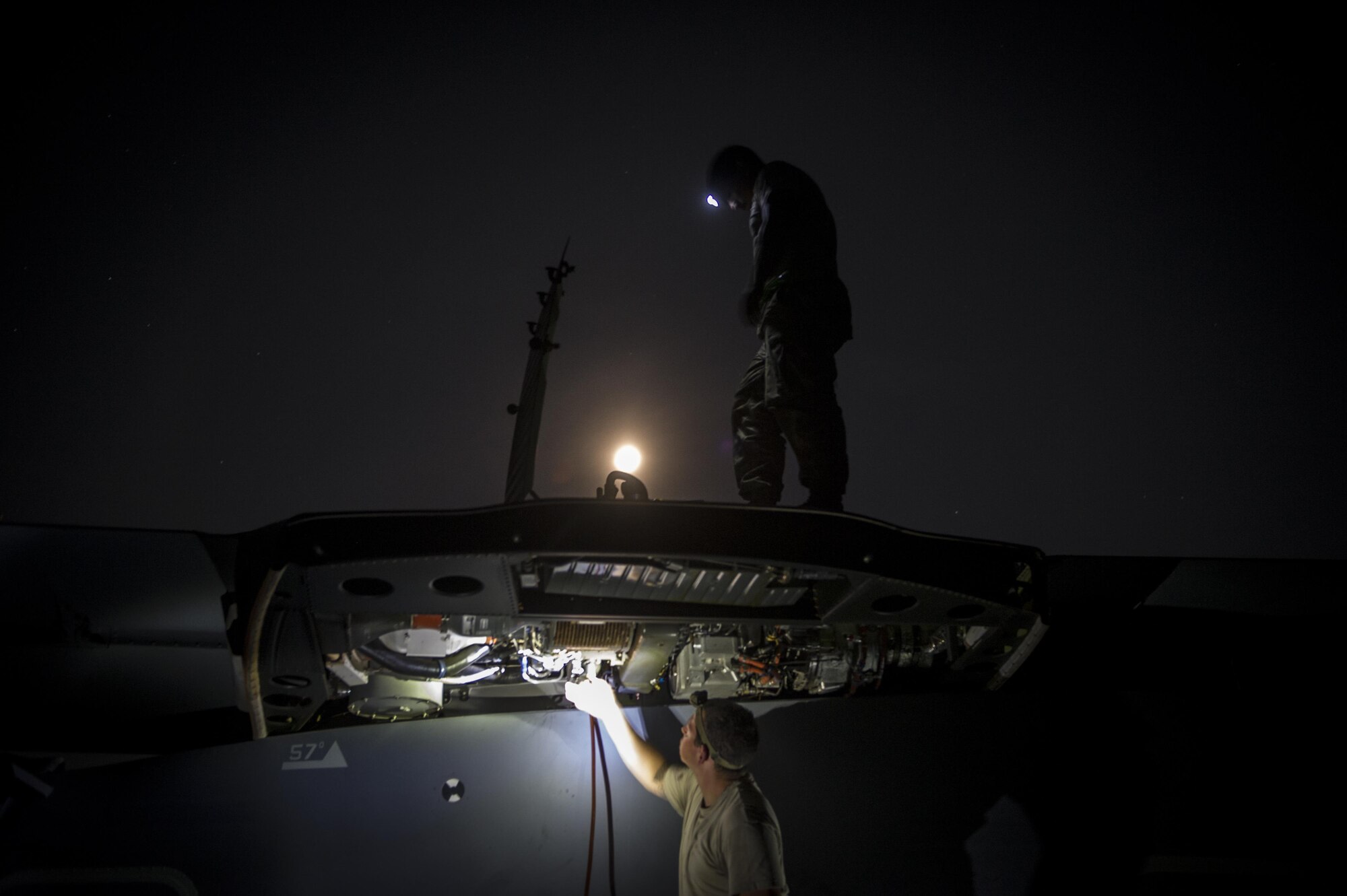 Staff Sgt. Kenneth Caicedo, 801st Special Operations Aircraft Maintenance Squadron electrician, stands on top of a CV-22B Osprey while Staff Sgt. Sam Johnston, 801st SOAMXS crew chief, attaches a hose to a fuel line during routine repairs on Eglin Range Complex, Fla., July 29, 2015. The Osprey played an integral role during a recent task force exercise at Hurlburt Field, Fla. (U.S. Air Force photo/Senior Airman Christopher Callaway)