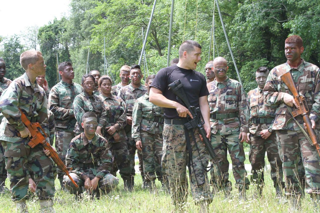 U.S. Marine Corps Staff Sgt. Justin E. Thurber, from Shawnee, Kansas, shows Air Force Junior Reserve Officer Training Corps cadets how to lead a patrol during the AFJROTC Chantilly Academy Cadet Leadership Course on Joint Base Andrews Naval Air Facility Washington, June 25, 2015. Thurber is staff noncommissioned officer in charge of Recruiting Station Frederick Recruiting Sub-station Chantilly. (U.S. Marine Corps photo by Sgt. Anthony J. Kirby/Released)