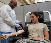 Senior Airman Katie Perry, member of the National Air and Space Intelligence Center, give blood during the bi-annual blood drive Tuesday, July28, 2015. There are about 30,000 units of blood used every day in the United States. (U.S. Air Force photos by Airman 1st Class Samuel Earick)     