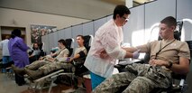Members from the National Air and Space Intelligence Center give blood during the bi-annual blood drive Tuesday, July28, 2015. There are about 30,000 units of blood used every day in the United States. (U.S. Air Force photos by Airman 1st Class Samuel Earick)     