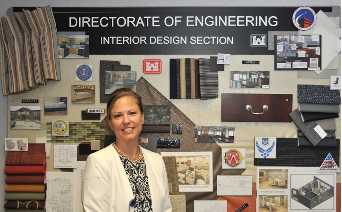 Patricia Mooneyham, a chief in the Interior Design Section, at the Engineering and Support Center, Huntsville, stands in front of an interior design sample board Wednesday, which was designed by several interior designers. Mooneyham will be presented with the U.S. Army Corps of Engineers 2015 Interior Designer of the Year award in August at the Huntsville Center.