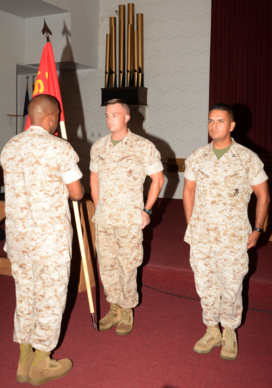 Gunnery Sgt. Billy Shanks, company gunnery sergeant, prepares to hand Marine Corps Logistics Base Albany’s Headquarters and Support Company’s colors to Capt. George McDonnell, company commander and deputy staff judge advocate. Capt. Cesar Gilcardona, logistics officer, took over as the new company commander during a ceremony at the installation’s Chapel of the Good Shepherd, Aug. 6. McDonnell handed Gilcardona the company’s colors signifying the change of command. Col. James C. Carroll III, commanding officer, MCLB Albany, welcomed Gilcardona to his new position and praised McDonnell’s achievements during his tenure as company commander.