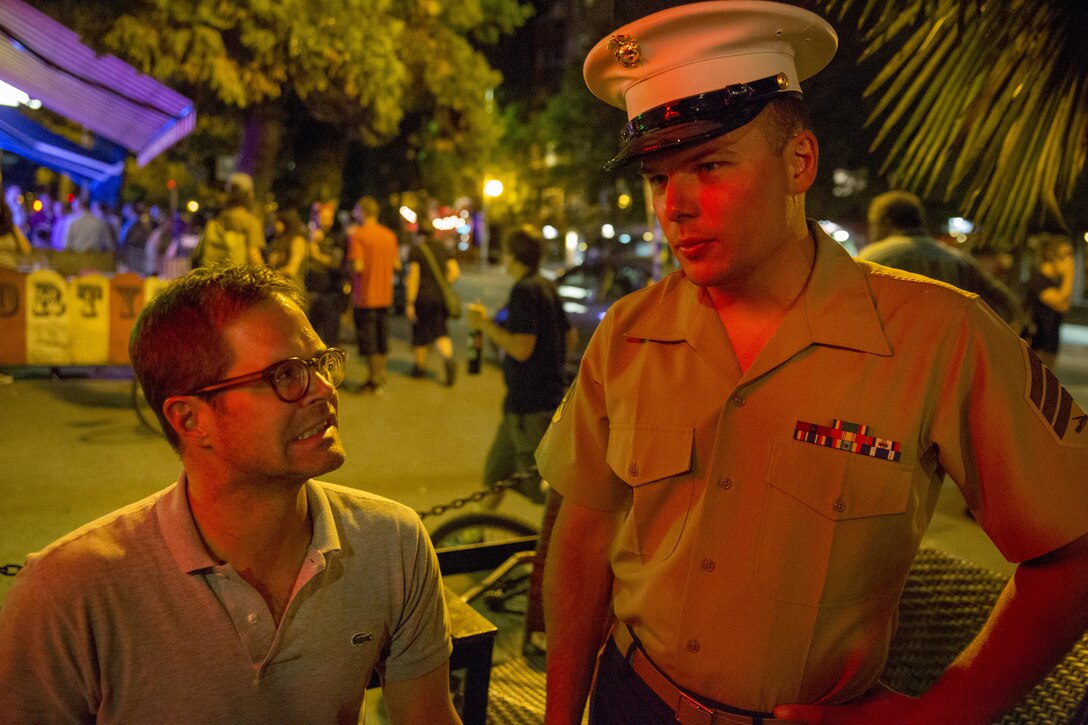 Sgt. Robert Farmsworth, a flight equipment technician with Marine Light Attack Helicopter Training Squadron (HMLAT) 303, and a St. George, Utah, native, converses with Charles Hamilton, a Seattle resident, and a Richmond, Virginia, native, while visiting businesses during Seafair Fleet Week in Seattle, July 31. Seafair Fleet Week gives Marines and Sailors the opportunity to interact with Seattle residents and demonstrate the value of America’s Navy-Marine Corps Team.