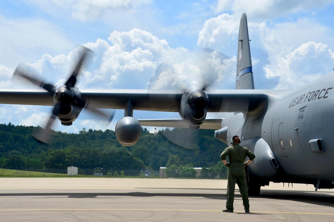 U.S. Air Force Tech. Sgt. Brian Krause watches a C-130 Hercules' turbo prop engine start up during the Patriot 2015 exercise at Volk Field Combat Readiness Training Center, Wis., July 22, 2015. Krause is assigned to the Texas Air National Guard's 181st Airlift Squadron.