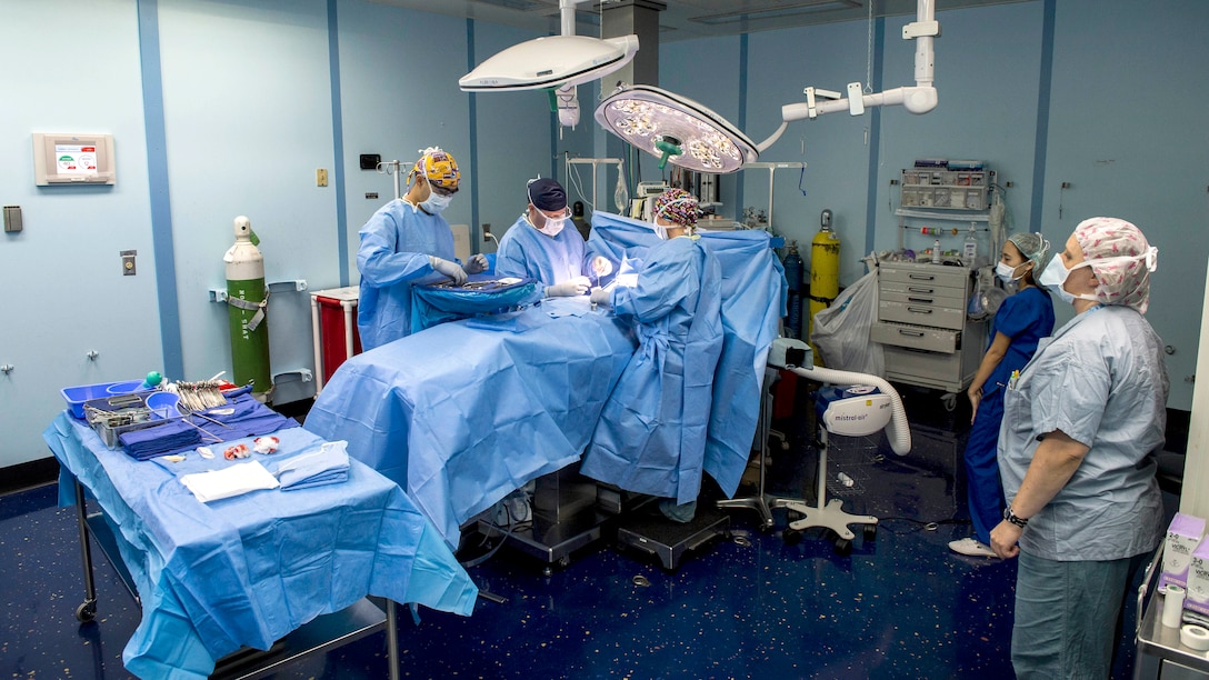 U.S. Navy medical personnel perform hernia repair surgery on a Filipino ...