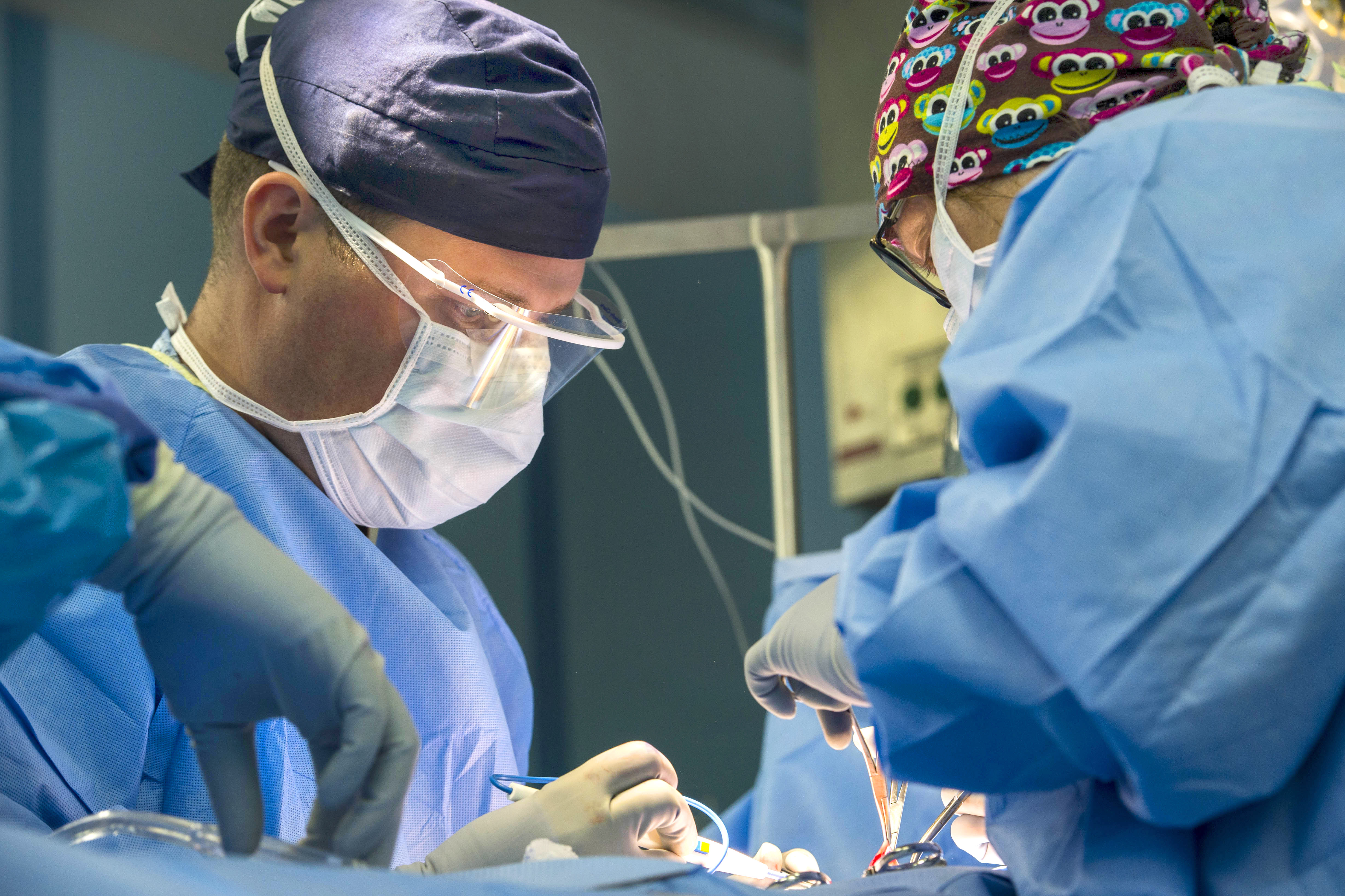 U.S. Navy Lt. James Wallace, left, and U.S. Navy Lt. Cmdr. Kristen Stevens  perform hernia repair