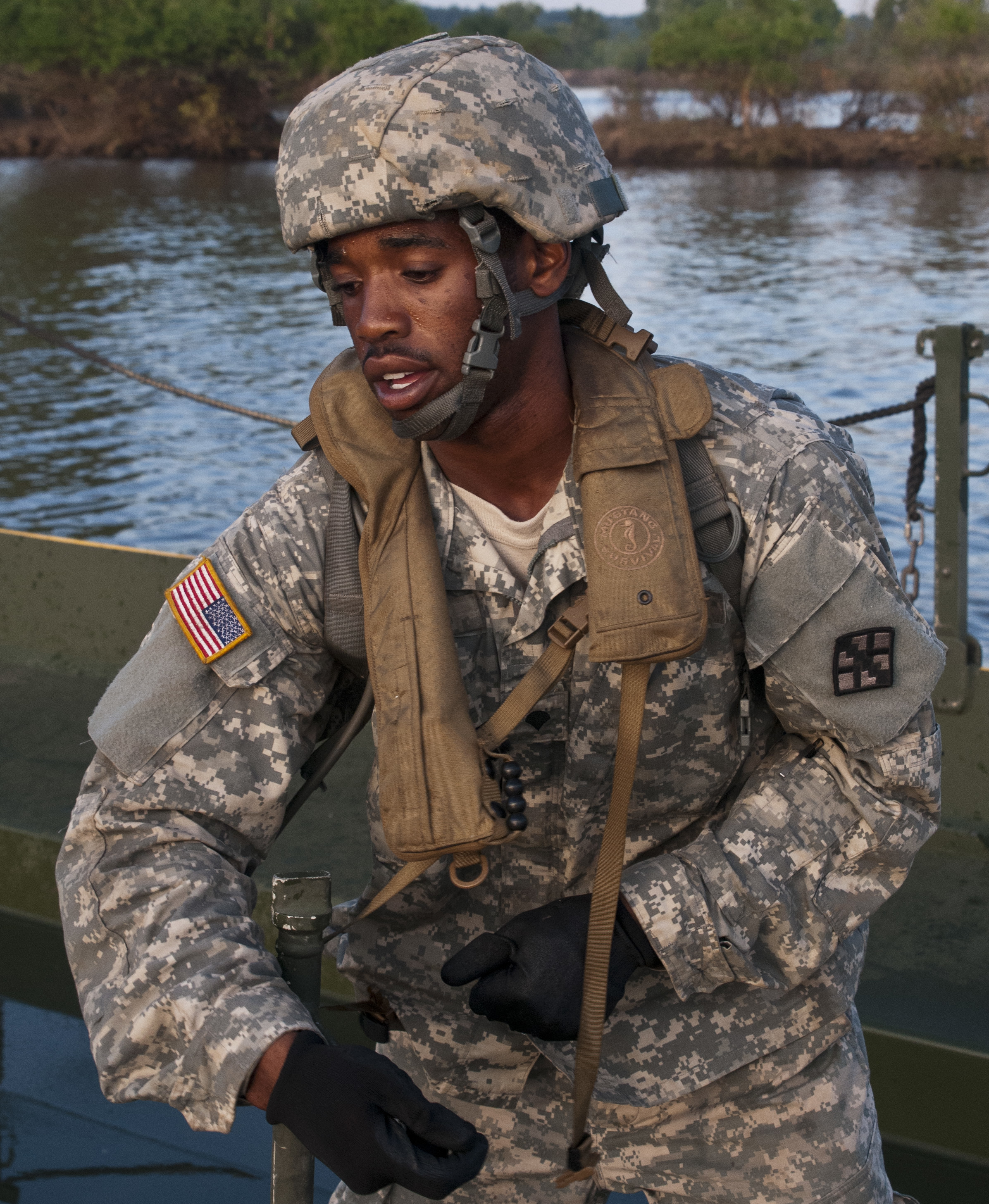 U.S. Army Spc. Jarvis Bigger secures two floats during the River