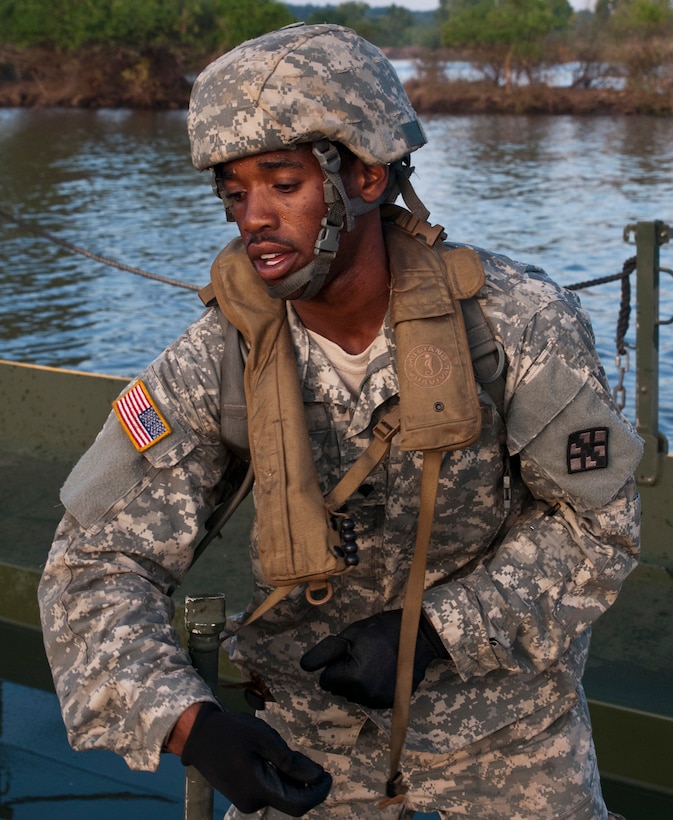 U.S. Army Spc. Jarvis Bigger secures two floats during the River Assault 2015 training exercise on Fort Chaffee, Ark., Aug. 4, 2015. Bigger is assigned to the 310th Engineer Company, Fort A.P. Hill, Va.