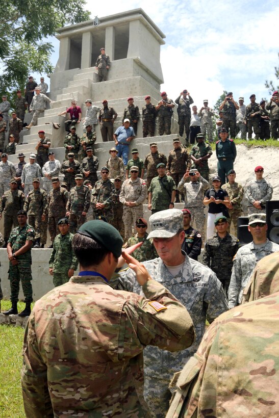 U.S. Army Lt. Gen. Joseph DiSalvo, deputy commander of U.S. Southern Command, center, returns a salute to a U.S. Special Forces soldier during the Fuerzas Comando 2015 closing ceremony in Poptun, Guatemala, July 23, 2015.
