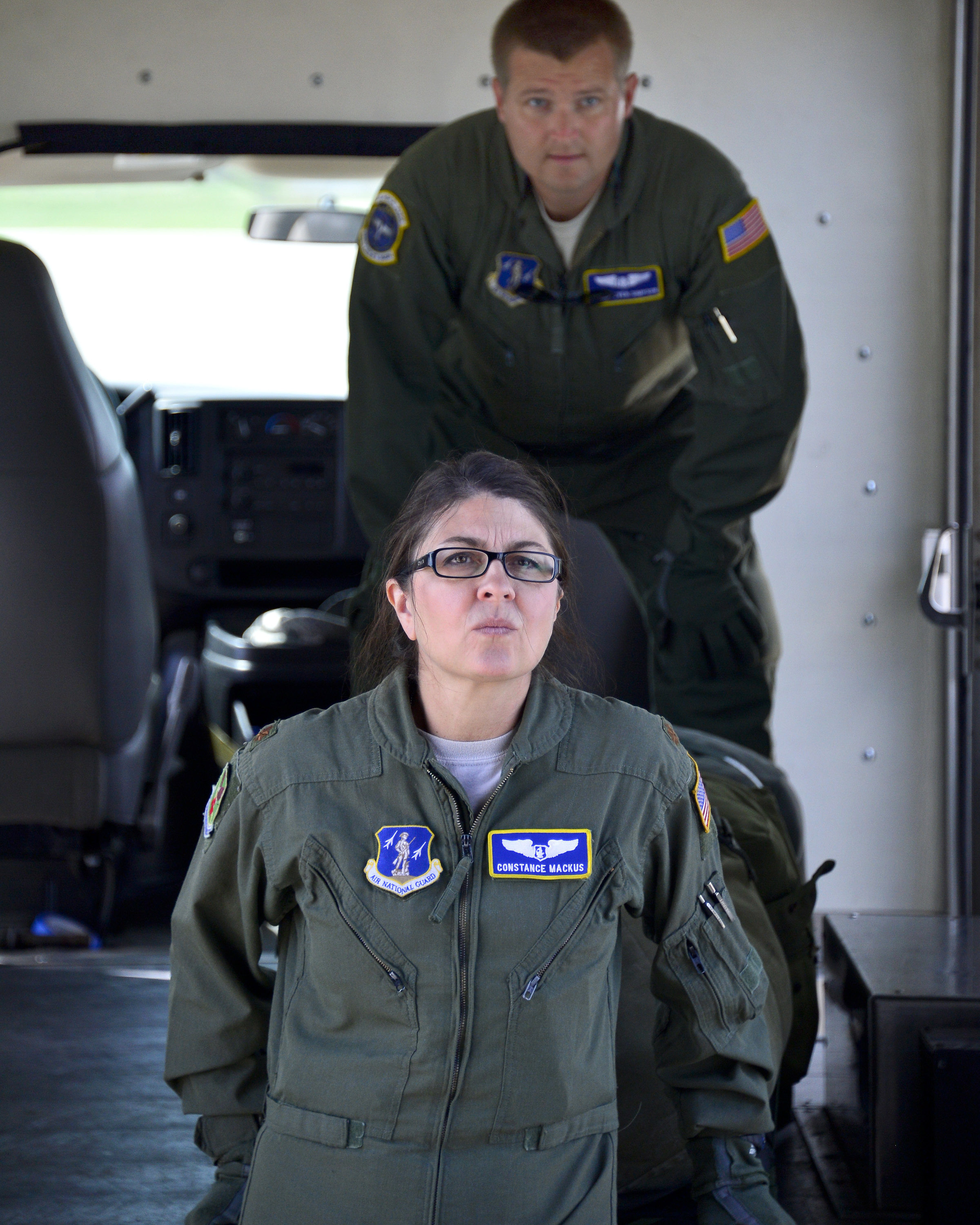 U.S. Air Force Maj. Constance Mackus, foreground, carries a litter to a ...