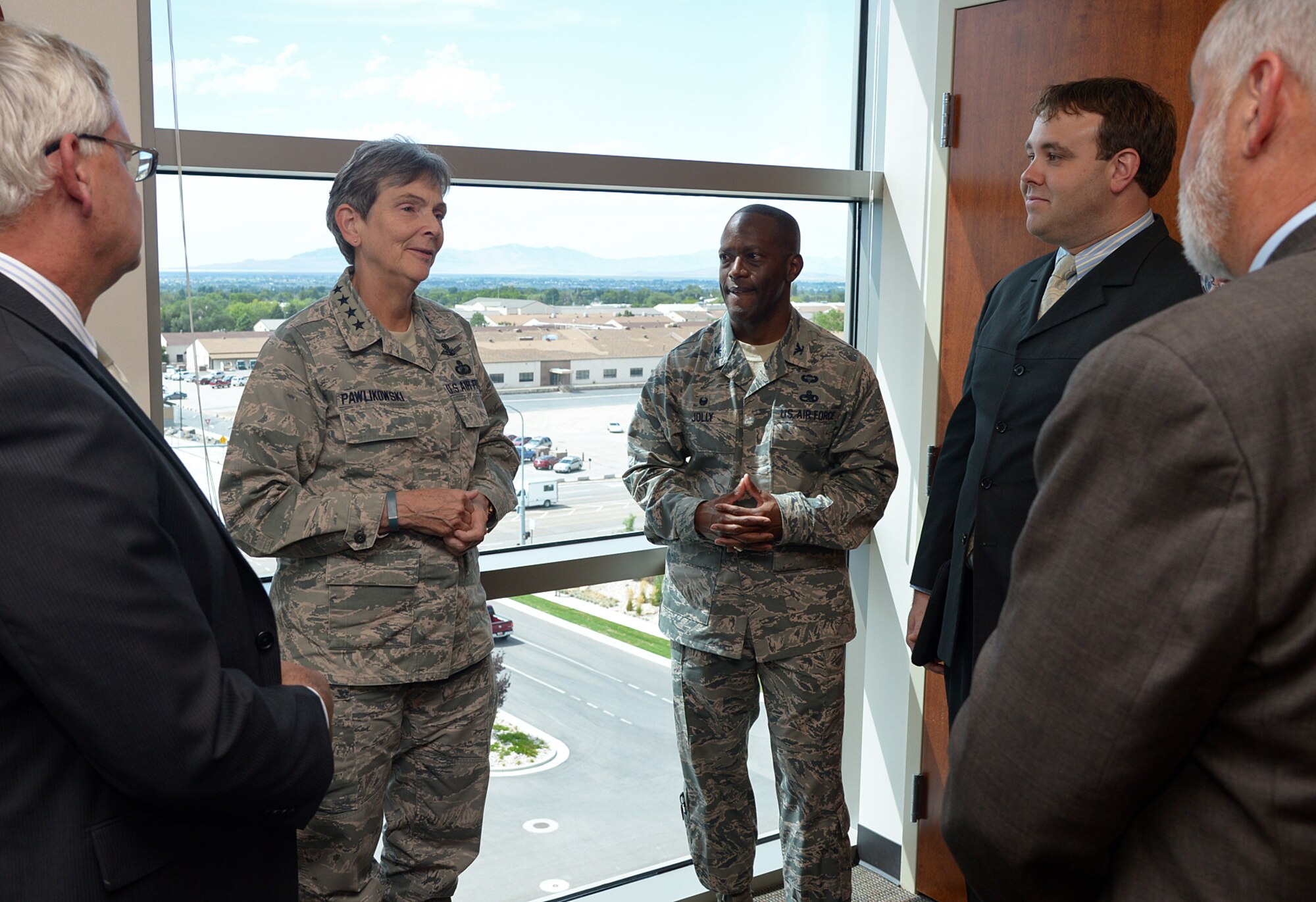 Gen. Ellen M. Pawlikowski, commander of Air Force Materiel Command, talks with Air Force Col. Ronald Jolly, 75th Air Base Wing commander, and Falcon Hill development team members about the Falcon Hill Enhanced Use Lease project Wednesday, Aug. 5, at Hill Air Force Base, Utah. EUL allows the Defense Department to lease underutilized property to a developer in exchange for value back to the Air Force in the form of new infrastructure, gates and buildings. The Falcon Hill project does not require any Air Force funding and no federal tax dollars. Once construction is completed, the Air Force will own and operate the government space. Until recently, an old building once stood where the parking to Pawlikowski’s left now resides.  (U.S. Air Force photo by Alex R. Lloyd/Released)