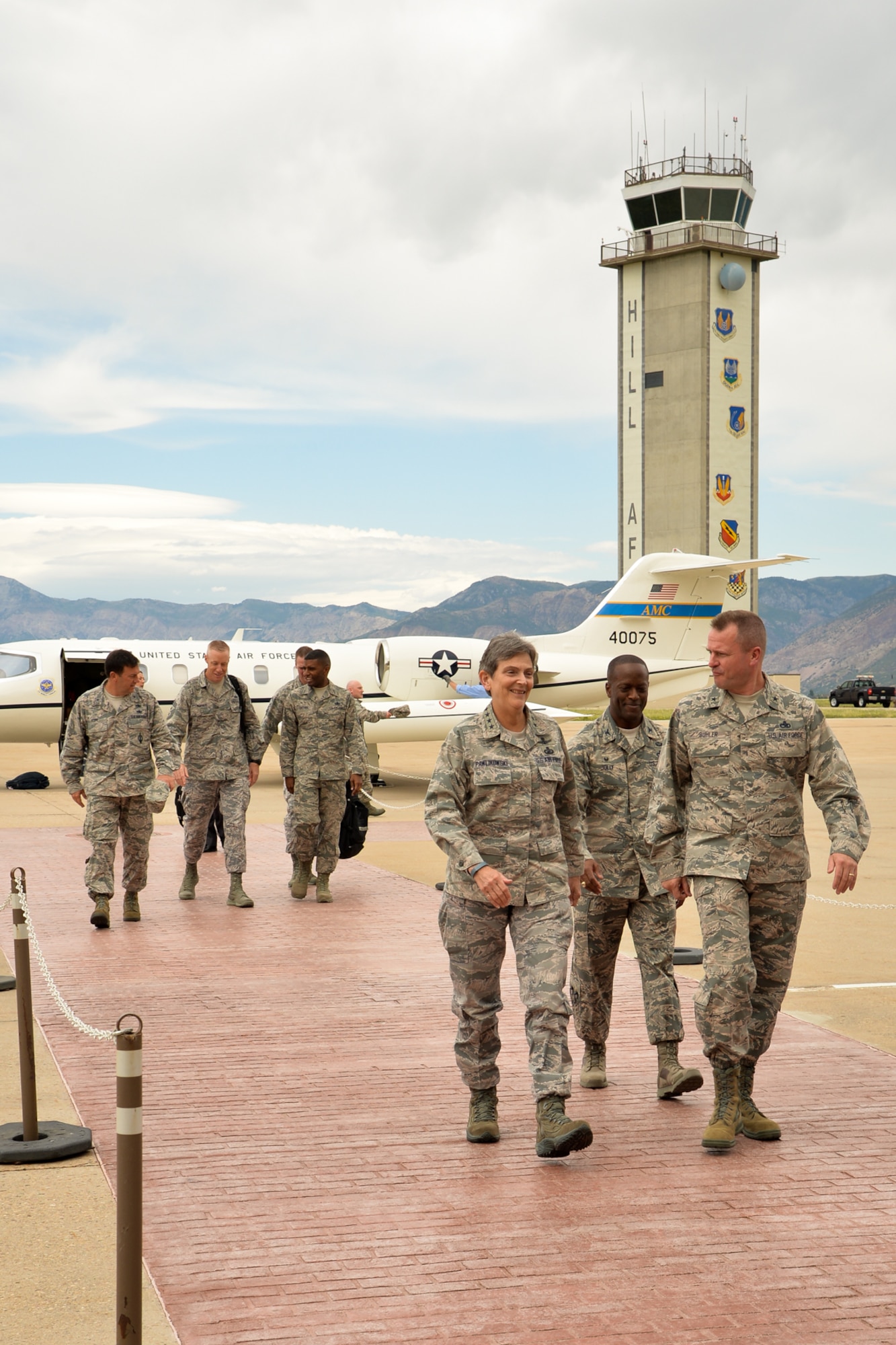Air Force Brig. Gen. Carl Buhler, Ogden Air Logistics Complex commander, and Air Force Col. Ronald Jolly, 75th Air Base Wing commander, walk with Gen. Ellen M. Pawlikowski, Air Force Materiel Command commander, toward base operations after her arrival at Hill Air Force Base, Utah, Wednesday, Aug. 5. During her visit, Pawlikowski saw firsthand how Air Force Sustainment Center units are implementing the AFSC Way, a leadership model that places emphasis on process discipline and accountability to improve performance and production. She also met with Team Hill Airmen and hosted an All Call with base personnel. (U.S. Air Force photo by R. Nial Bradshaw/Released)