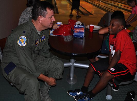 (Left to right) Lt. Col. Glenn Clark, 931st Air Refueling Group Stan Eval Chief, discusses basketball with his "little," 9-year-old Rogdreck after bowling at the Robert J. Dole Community Center Aug. 6, 2015, at McConnell Air Force Base, Kan.  McConnell Reservists took time from their busy schedules to bond with more than 50 boys and girls from the local Big Brothers Big Sisters program during the annual "Big For A Day" event. The event was hosted by the active duty 349th Air Refueling Squadron.  (U.S. Air Force photo by Tech. Sgt. Abigail Klein)